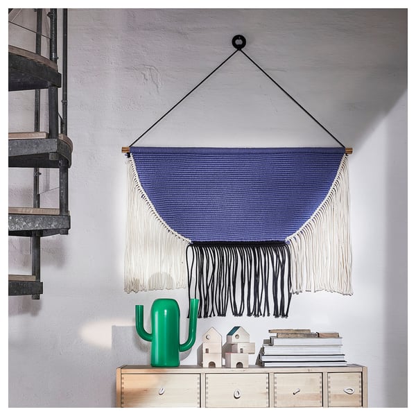 Simplify: blue wall hanging with fringes; modern decor.