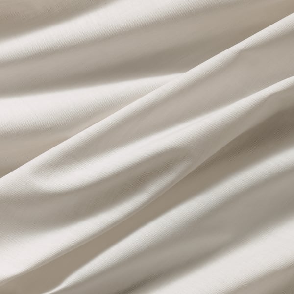 Cream cotton fabric, smooth, softly lit folds.