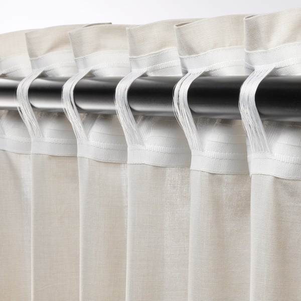 Curtain rod with sheer white curtains, featuring pleated tops and tab backs for easy hanging, offering light filtration and privacy.