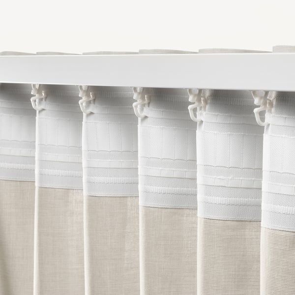 White curtains with hooks hanging neatly, offering privacy and light control.