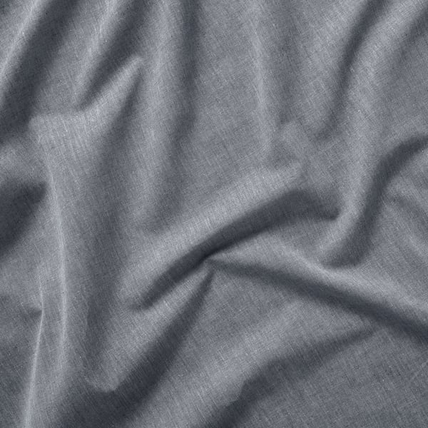 Soft, textured fabric close-up. Light grey cotton curtains, slightly wrinkled, hanging straight.