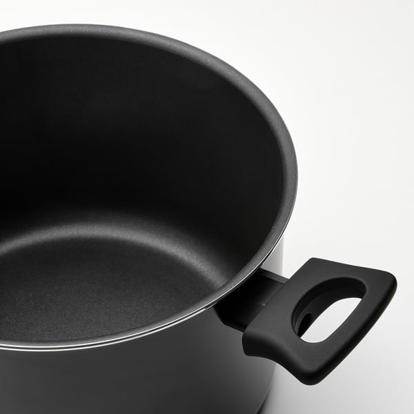 Close-up of a black pots handle and interior, shows smooth non-stick surface.