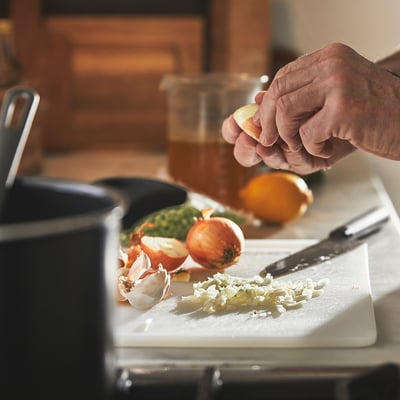 Preparing meal with fresh ingredients on a cutting board.