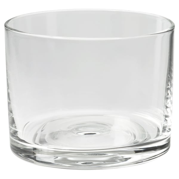 A clear glass HÖSTAGILLE candle holder. It has a cylindrical shape with a smooth, round base. The simple, transparent design is elegant and versatile.