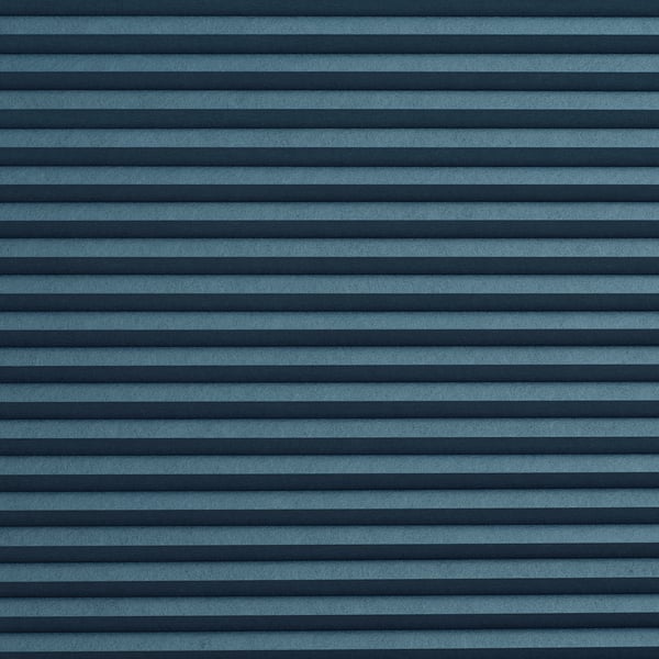 Blue striped room-darkening cellular blind, horizontally patterned, texture visible, mounted on wall or ceiling, creating warm privacy.