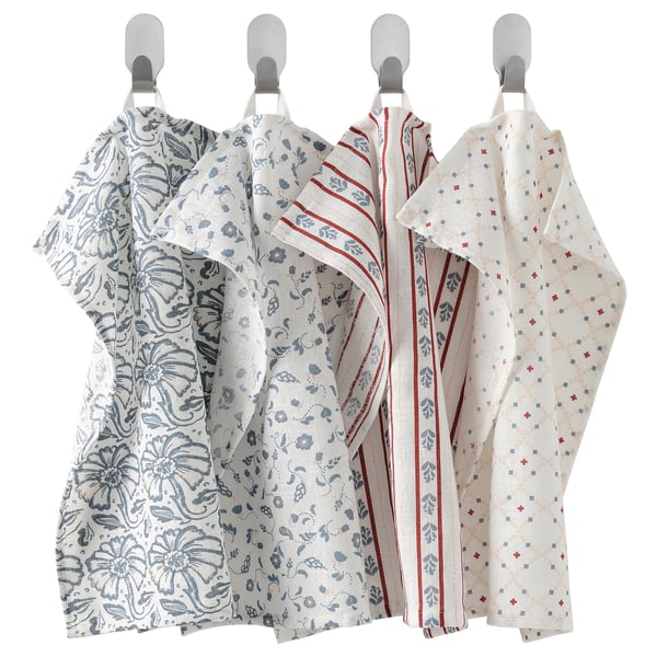 Four white towels with blue/red patterns hang neatly, featuring unique designs. Cotton, looped for easy hanging.