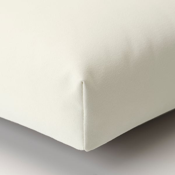 A plush, off-white cushion with clean stitching, indicating high-quality craftsmanship and durability.