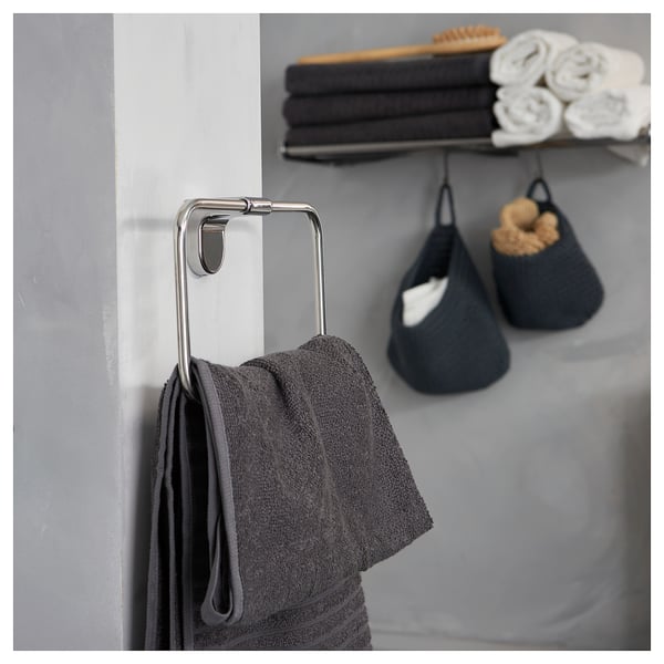 KALKGRUND towel holder with dark grey towel. Wall stacked with dark grey & rolled white towels.