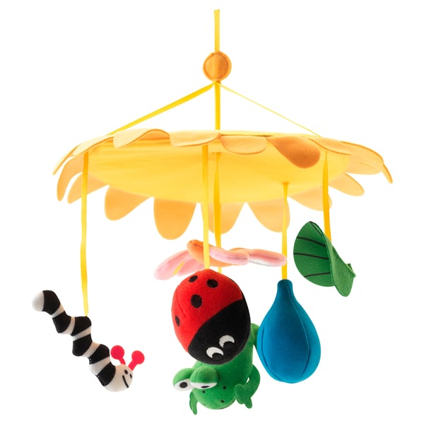 KLAPPA colourful baby mobile, featuring red ladybird, green caterpillar, and blue leaf. Bright yellow daisy backdrop. Soft fabric materials.