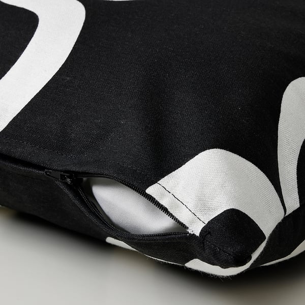 Black and white patterned cushion cover with zip detail, part of IKEAs sustainable nytillverkad collection.