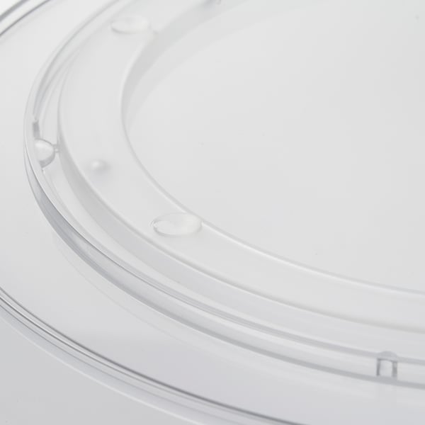 Clear plastic turntable with smooth edges, central hub, and rotating base, ideal for organising kitchen items.