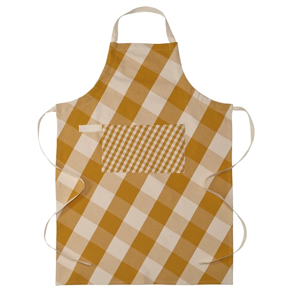 Apron named KÖSSEBÄR, featuring yellow and white chequered design, with adjustable straps and a front pocket, made of 100% cotton.