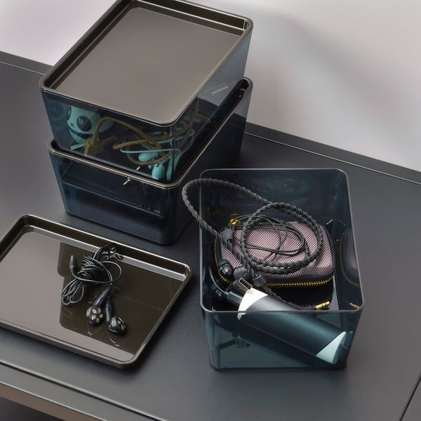 Clear storage boxes with lids for earphones, cables, and chargers.