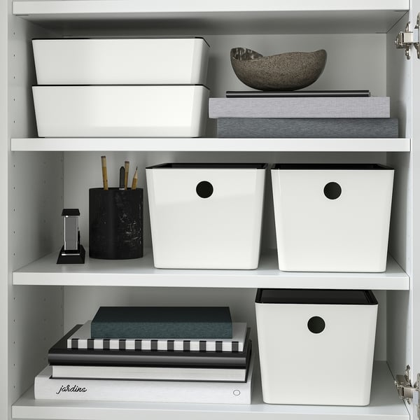 Shelf with KUGGIS boxes for storing items, stacking safely with lids, and a cup with writing tools.