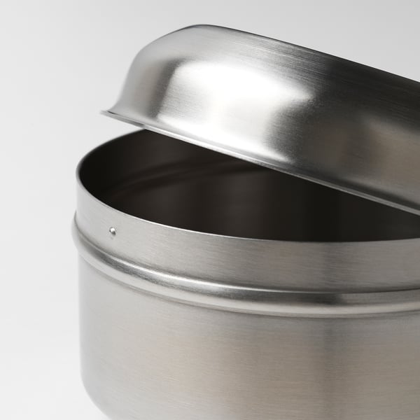Silver metal snack container with lid partially open, displaying smooth, polished surface and sturdy design.