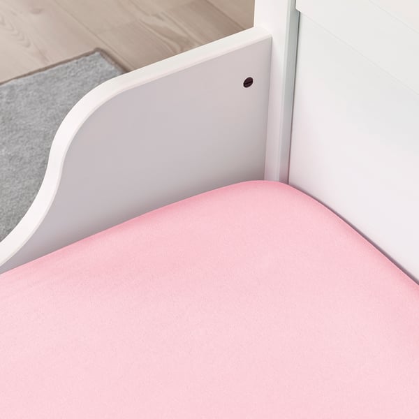 Pink fitted sheet for kids bed, securely stays on mattress with elastic edging.