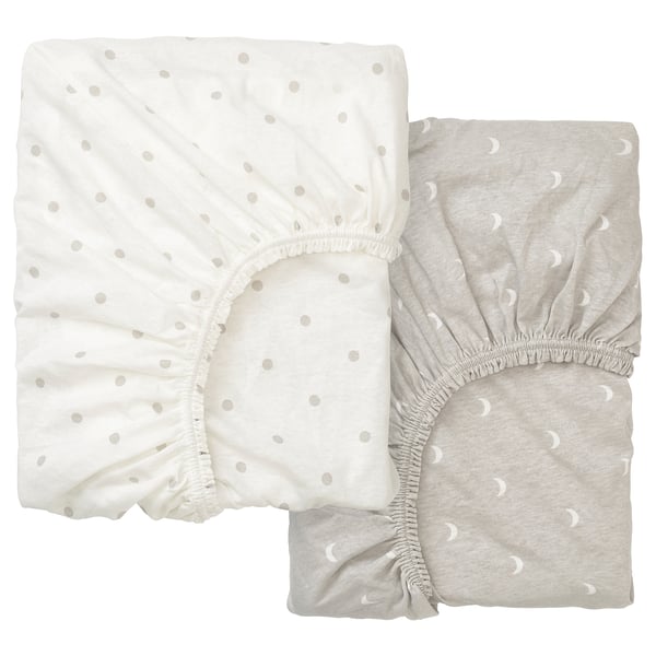 Two light-colored fitted sheets with dot patterns, one white and one grey, folded neatly.
