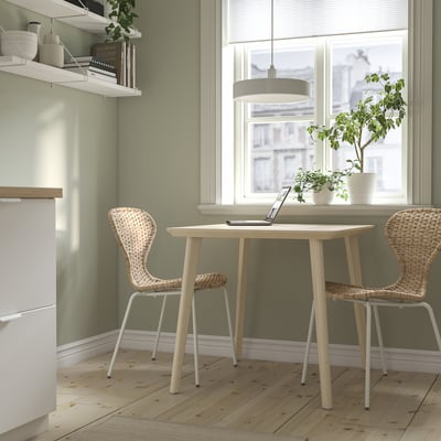 LISABO dining table and wicker chairs by window, cosy ambiance.