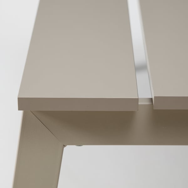 Hígh-quality close-up of sleek, minimalist table edge; smooth, grey finish; seamless design detail.