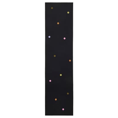 A black IKEA MÄVINN cotton runner with multicoloured crochet dots.