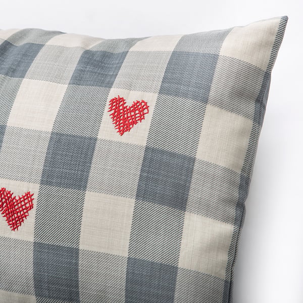 Chequered cushion with two red heart embroideries, showcasing high-quality craftsmanship and attention to detail.