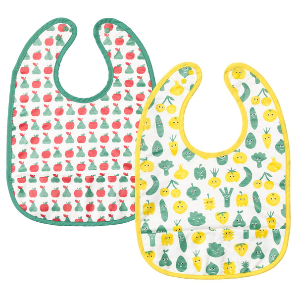 Two childrens bibs, one with red apple print, the other with yellow vegetable faces. Both have colourful borders and a soft back.