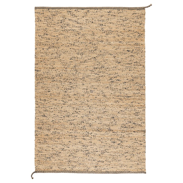 A handmade MELHOLT rug with natural jute and wool fibres, featuring random dark wool specks for unique texture and colour variation.
