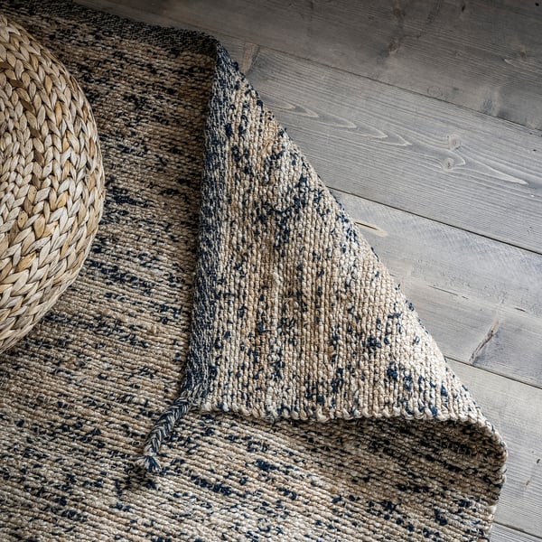 Rustic MELHOLT jute rug, black accents, rectangular. Handwoven, natural fibres, organic texture, cosy home decor.