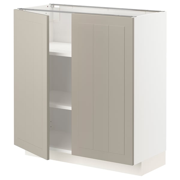 A beige METOD cabinet with two doors open, revealing shelves inside.