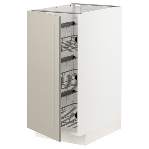 A white METOD kitchen cabinet with beige stensund fronts, featuring multiple pull-out wire baskets for storage.