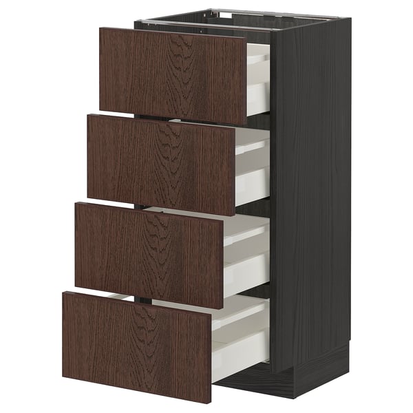 Dark brown kitchen cabinet with four wooden drawers, pulled out slightly.