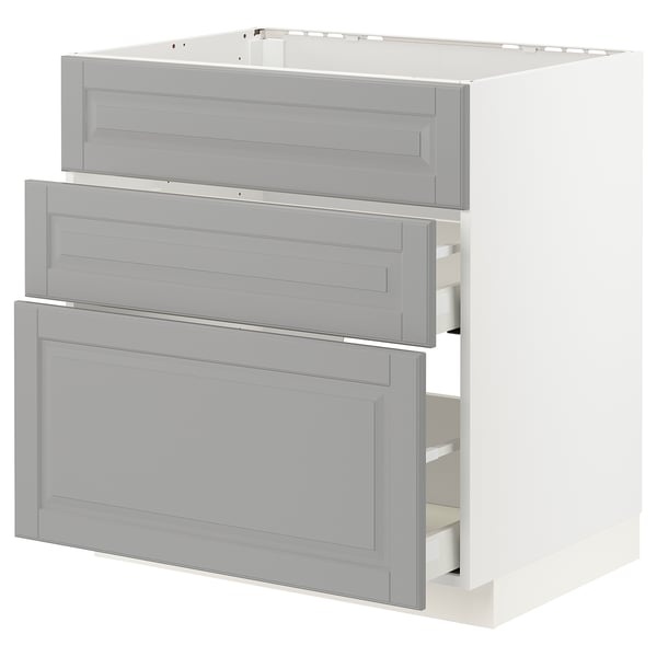 A METOD kitchen cabinet with three grey bodbyn drawers.