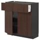 Dark brown kitchen cabinet, featuring open drawers and doors with wooden handles, set against a white background.
