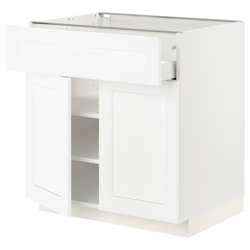 White kitchen cabinet with single door and shelf.