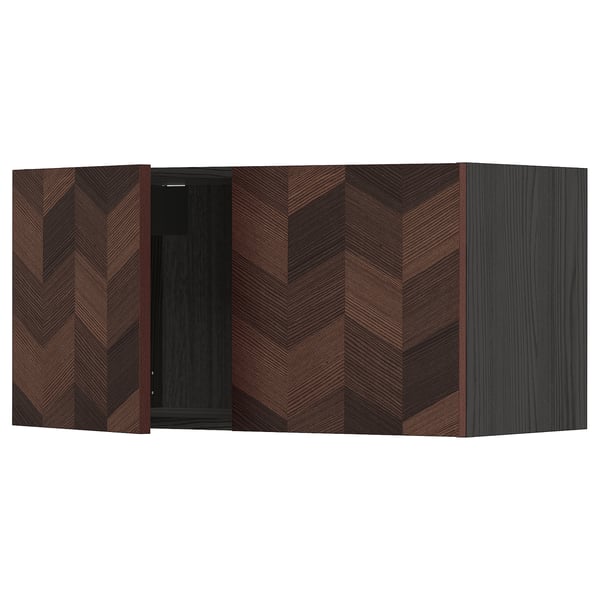 Modern dark brown kitchen unit with chevron pattern, featuring open door, part of IKEAs METOD system.