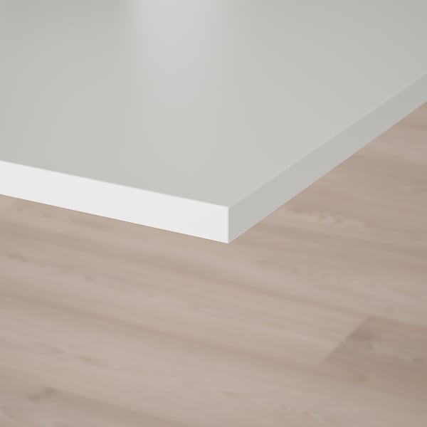 White melamine tabletop on wooden floor.