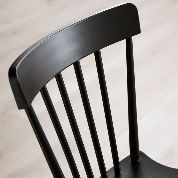 Black wooden chair with smooth, rounded design. Vertical slats and sturdy construction, polished to a sleek finish.