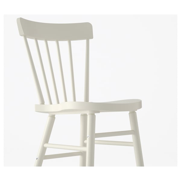 White spindle chair with curved back, solid wood legs, clean-lacquered for easy cleaning.