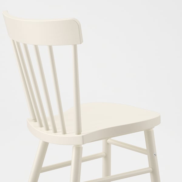 White spindle chair with rounded edges; sturdy, clean-lined, and comfortable.