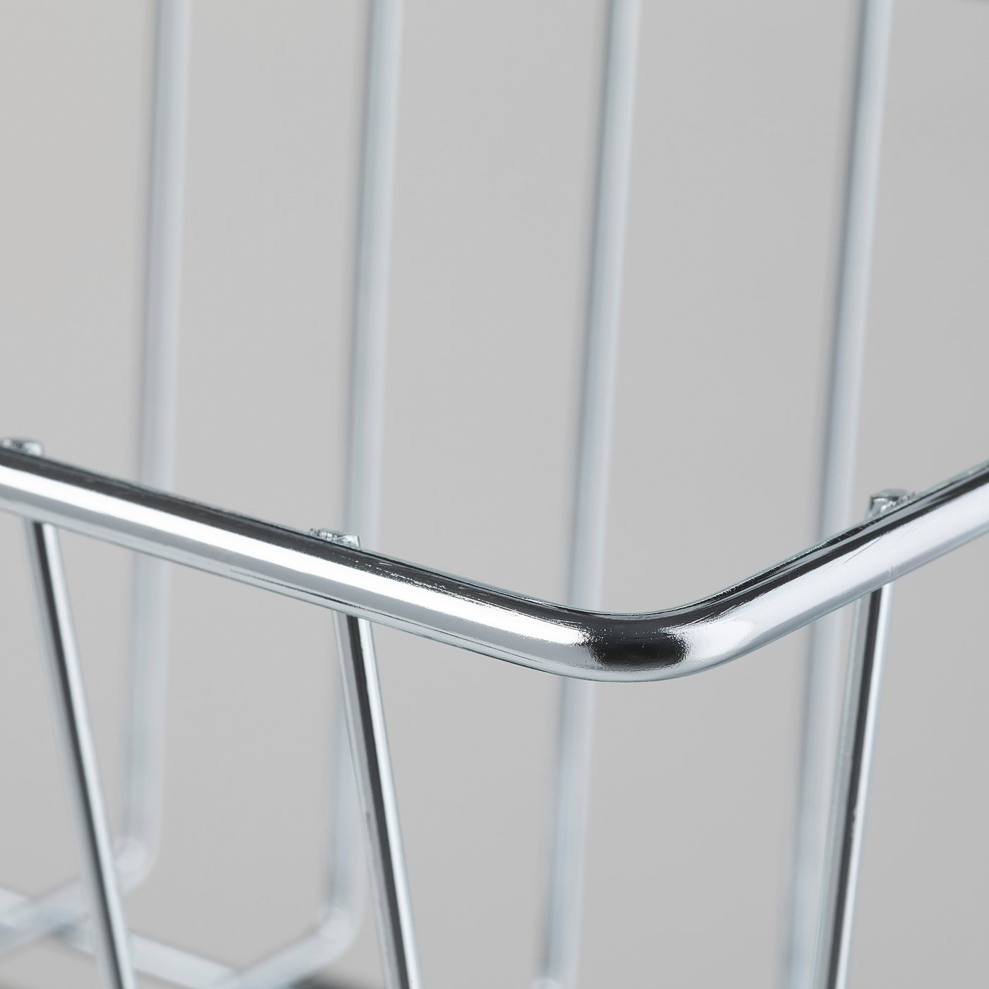 Close-up of a shiny, silver wire basket corner joint, showcasing sturdy metal construction and clean welds.