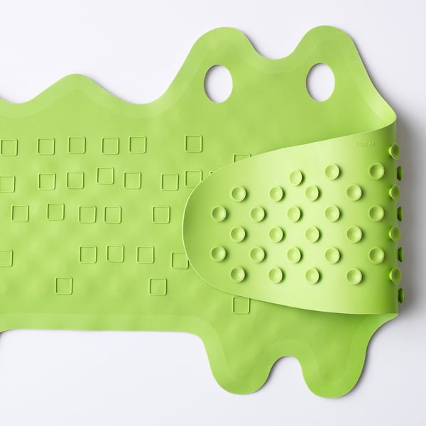 A lime green bath mat with suction cups, designed to prevent slipping and can hang for drying.