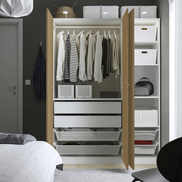 Open wardrobe with clothes, shelves, storage, and mesh baskets.