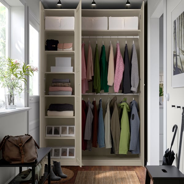 Organised closet with clothes, shelves, boxes, and hanging rail for efficient storage.