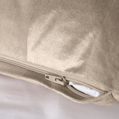 Close-up of beige cushion cover with zip, showcasing textured stripes.