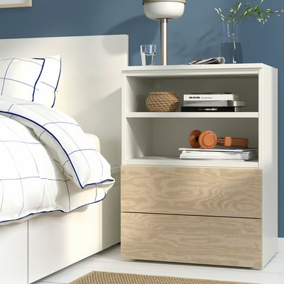 Modern bedroom with PLATSA storage unit. Shelves holding books, vase, and lamp, with drawers below.