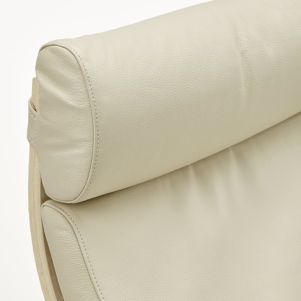 Close-up of poang chairs padded headrest, showcasing smooth, high-quality cream leather with neat stitching.