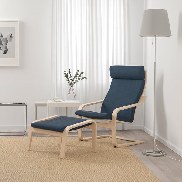 Blue POÄNG chair & footrest, wooden, striped curtains, side table, lamp. Compact, comfy.