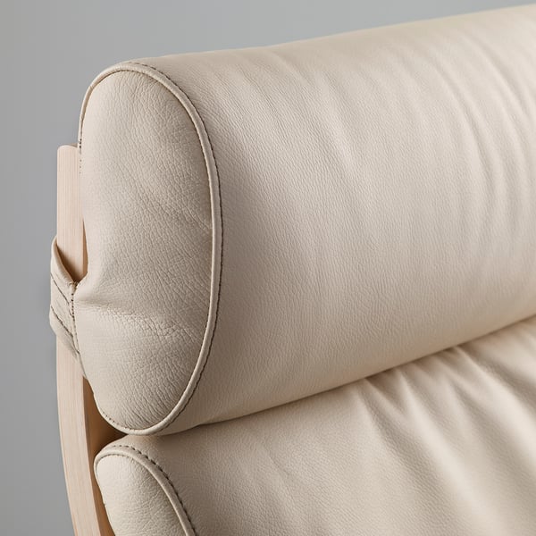 Close-up of a beige leather headrest on a sofa, showcasing stitching and soft texture.