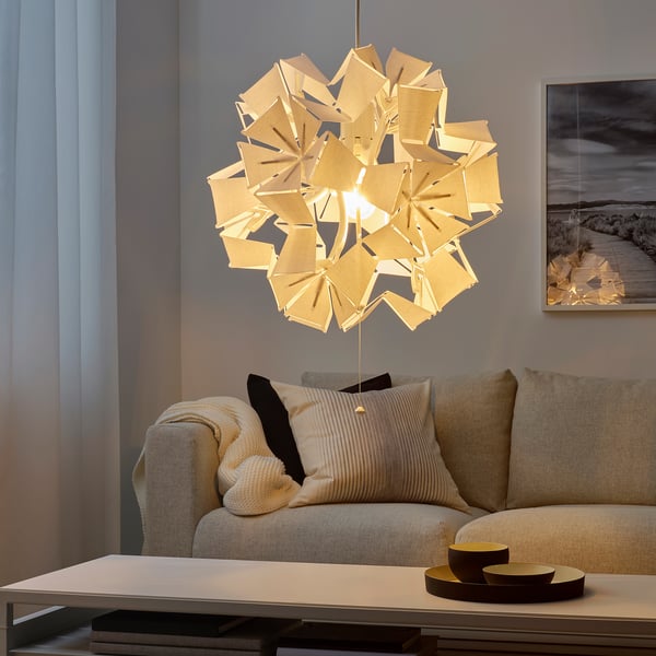 RAMSELE pendant lamp with warm light and ceiling patterns in living room.