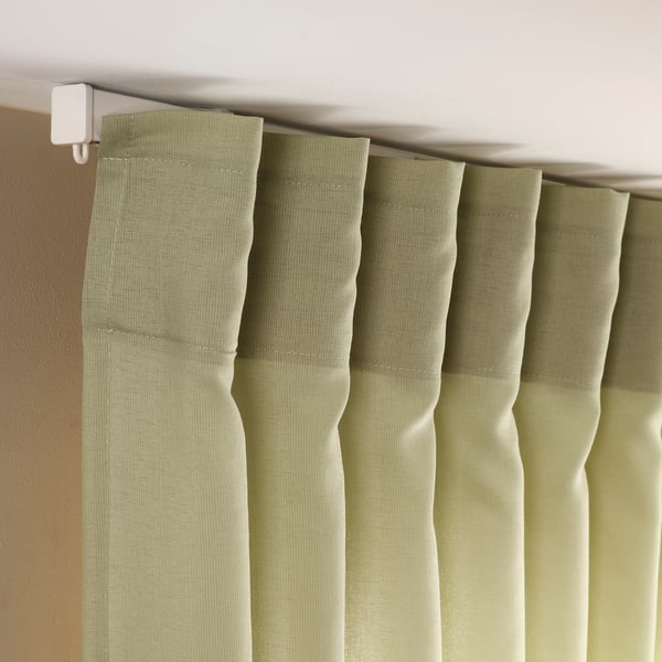 Olive green sheer curtains hang gracefully, filtering light and ensuring privacy, enhancing window decor.